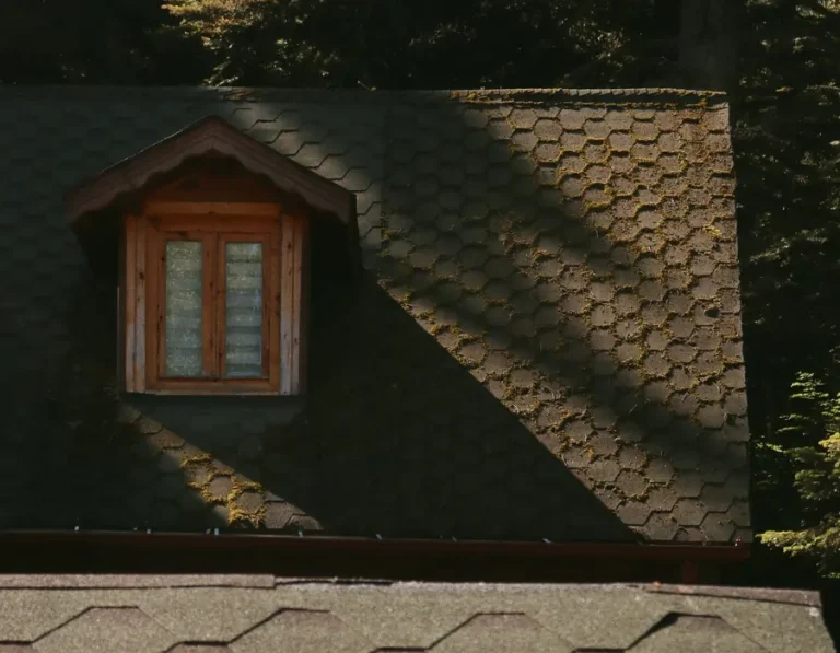 Architectural asphalt shingles around a roof dormer