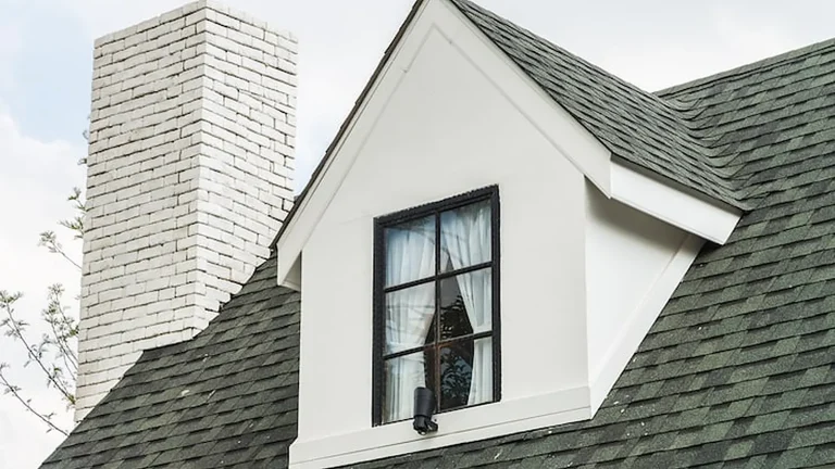 Shingle roof, dormer and chimney checked during a roof inspection in Olympia, WA