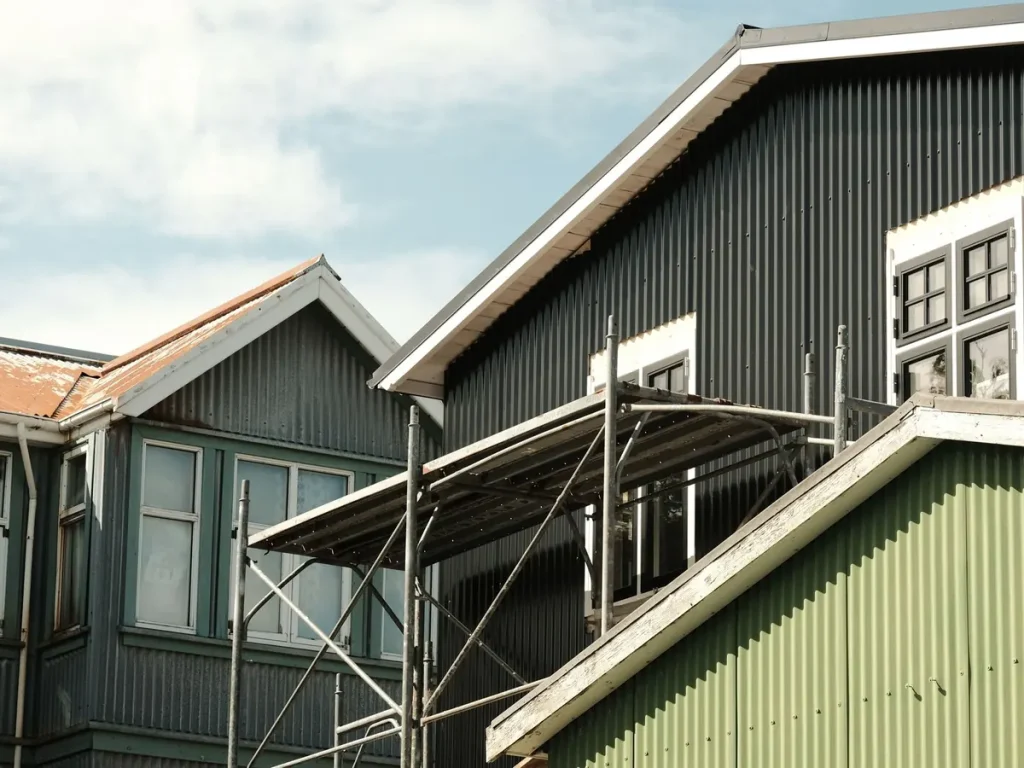 Homes with metal roofing and scaffolding during a reroof in Tumwater, WA