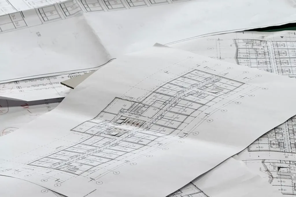 Roof plans on paper used to estimate roof replacement cost in Olympia